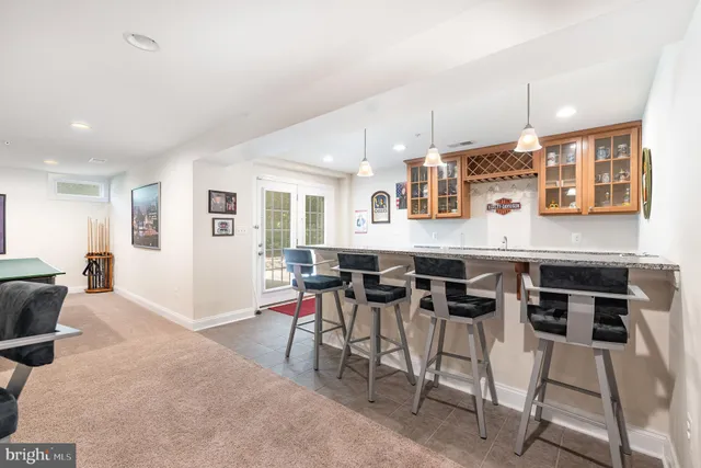 a kitchen with a dining table chairs and large window