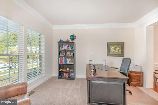 a work room with furniture and a floor to ceiling window
