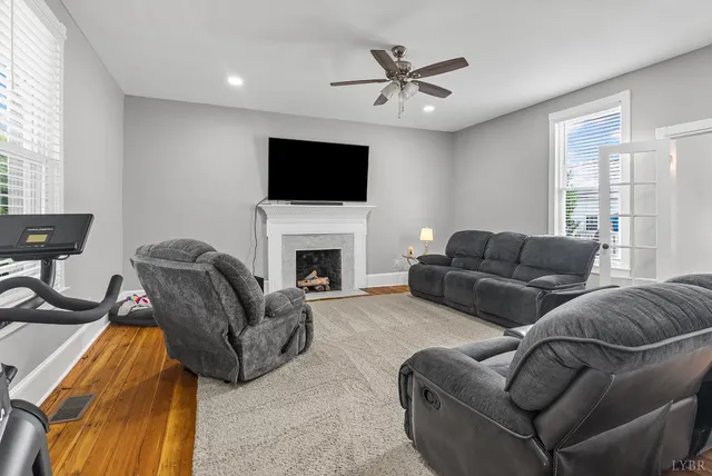 a living room with furniture and a ceiling fan