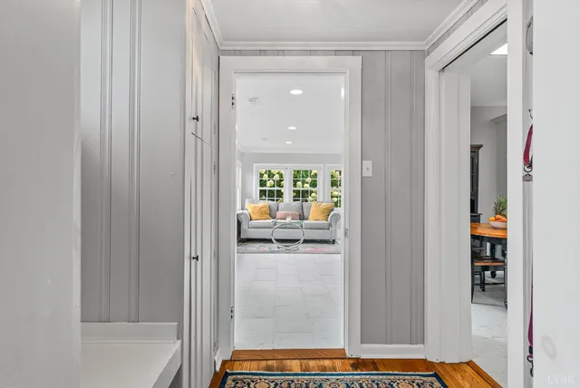 a bathroom with a granite countertop toilet a sink a mirror and a window