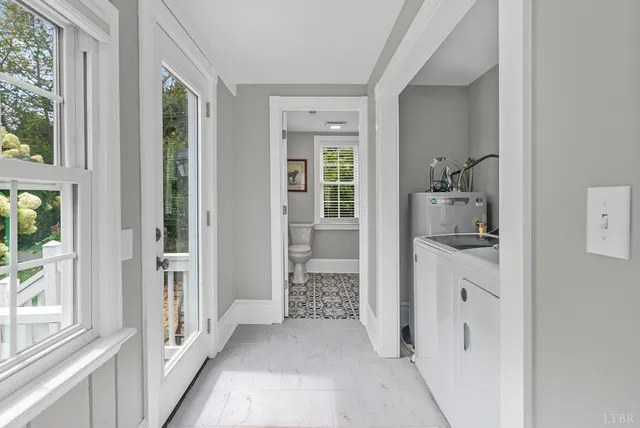 a living room with furniture a rug and a chandelier