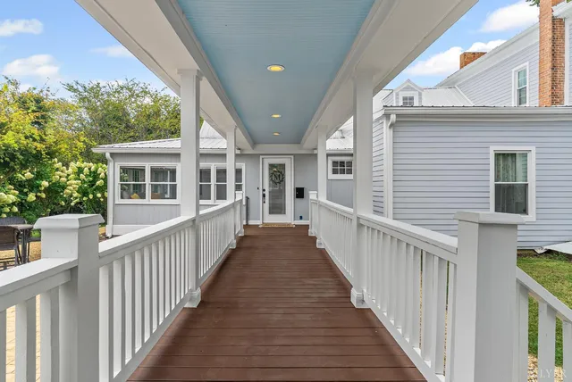 a view of a house with a backyard porch and sitting area