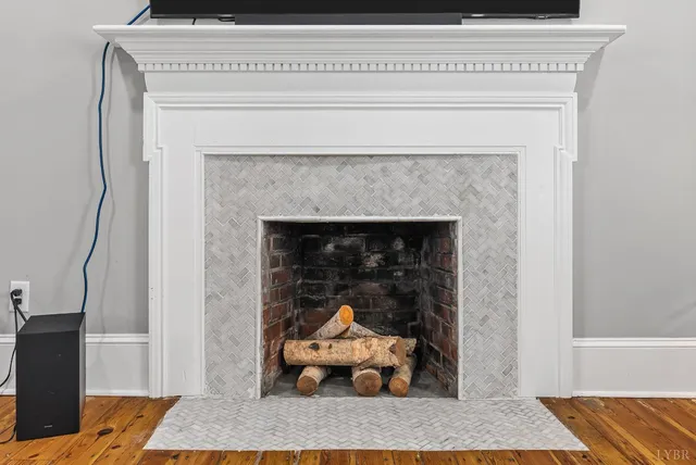 a living room with a fireplace and a rug