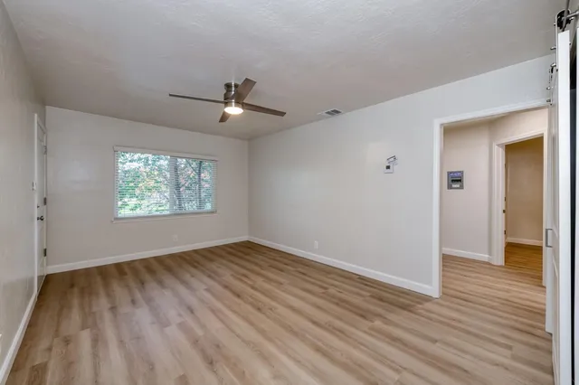 wooden floor in an empty room with a window