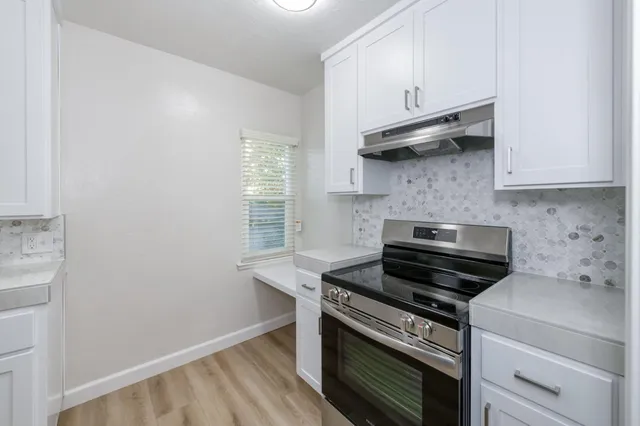 a kitchen with a stove and a microwave