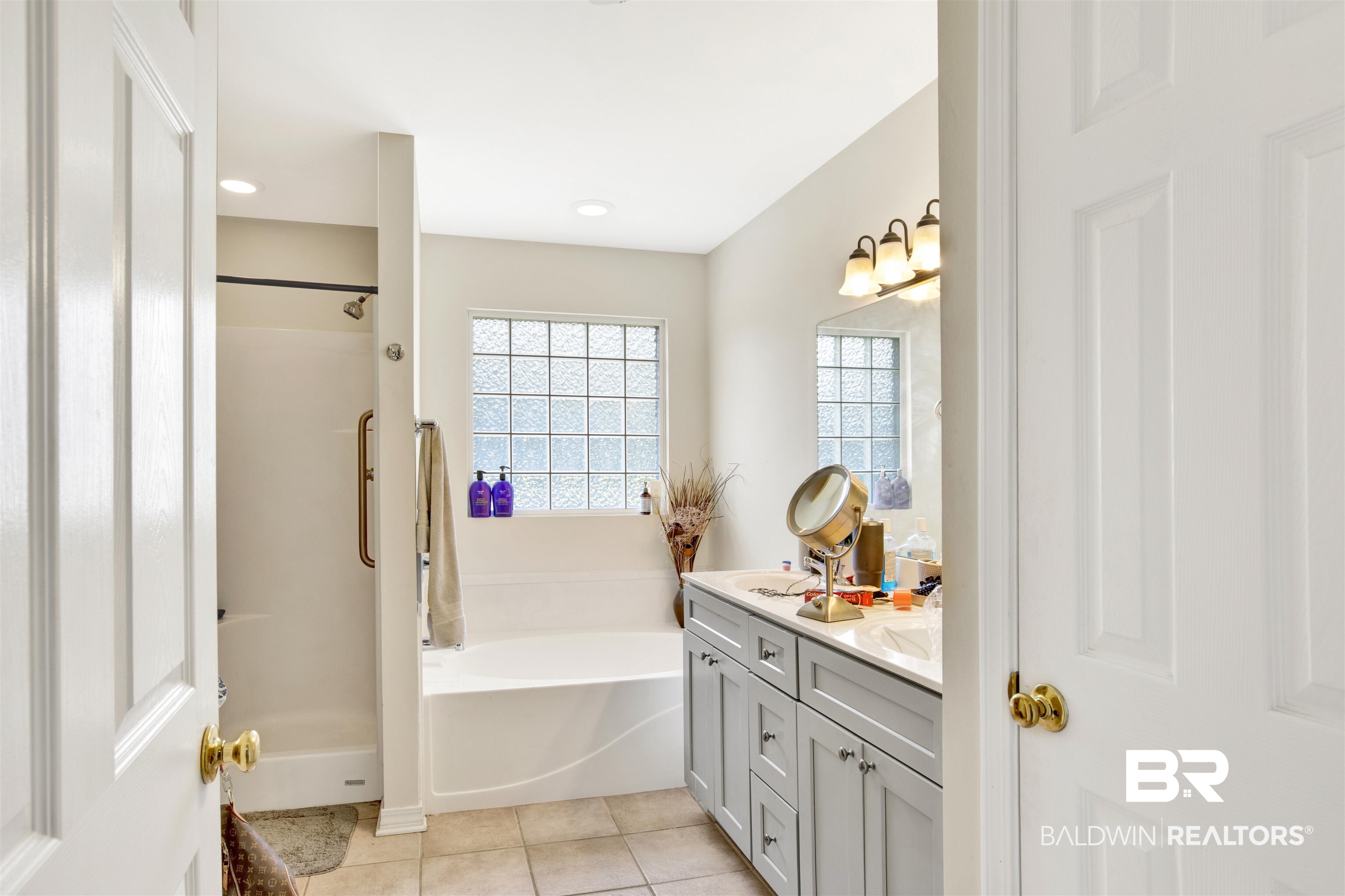 24384 Sailfish Lane Orange Beach, AL 36561 - Photo 15 of 23 Bathroom with tile patterned floors, double vanity, and a bathing tub