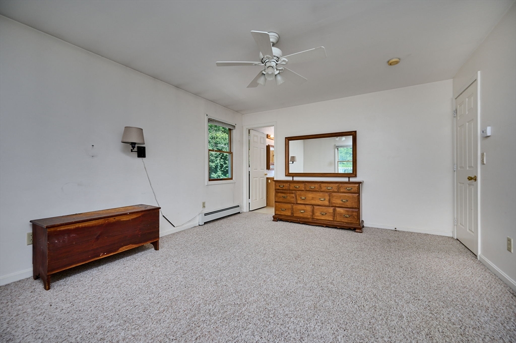 43 Loudville Road Easthampton, MA 01027 - Photo 12 of 34 a room with a bed and a chandelier