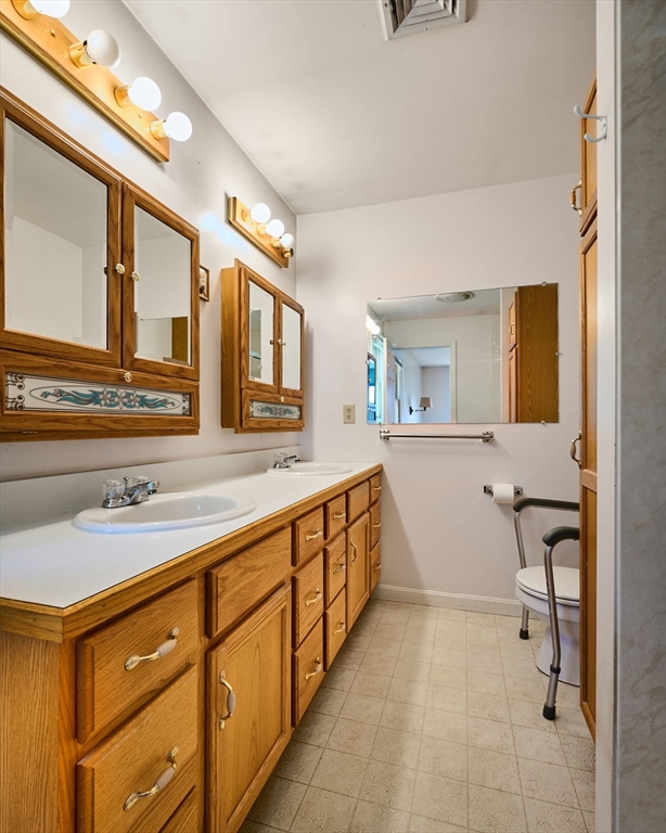 43 Loudville Road Easthampton, MA 01027 - Photo 13 of 34 a spacious bathroom with a double vanity sink a mirror and a bathtub