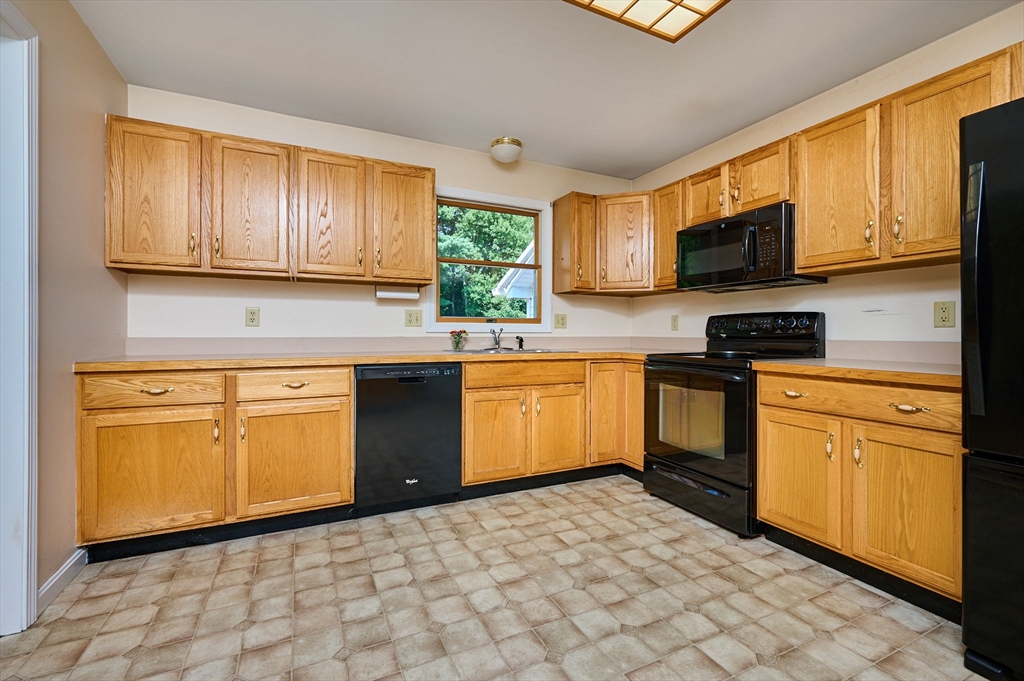 43 Loudville Road Easthampton, MA 01027 - Photo 5 of 34 a kitchen with granite countertop a stove top oven sink and cabinets