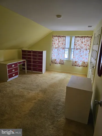 a view of a room with furniture and a window