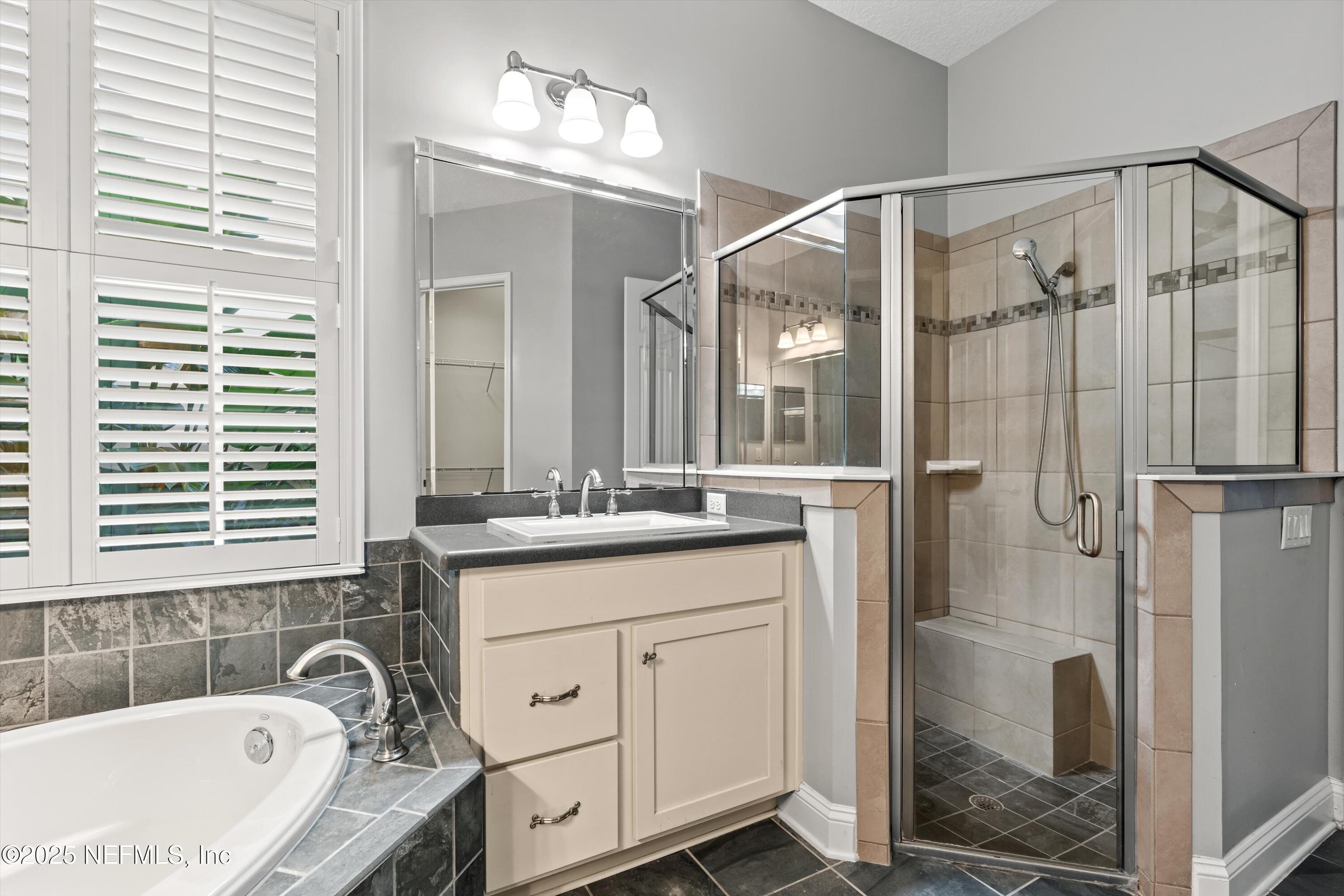 30 Pelican Pointe Road Ponte Vedra, FL 32081 - Photo 23 of 66 a bathroom with a tub sink and mirror