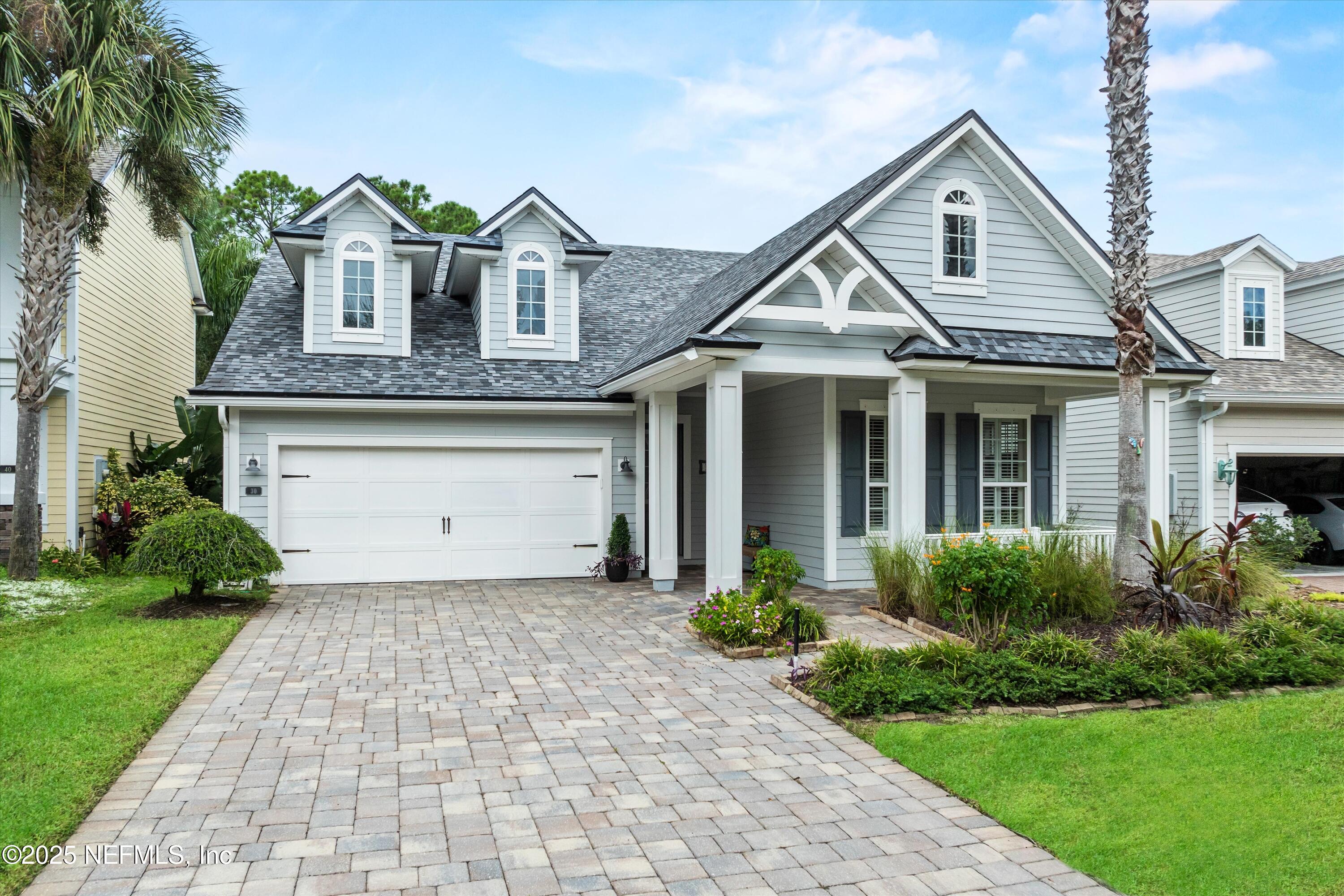 30 Pelican Pointe Road Ponte Vedra, FL 32081 - Photo 3 of 66 a front view of a house with a garden and plants