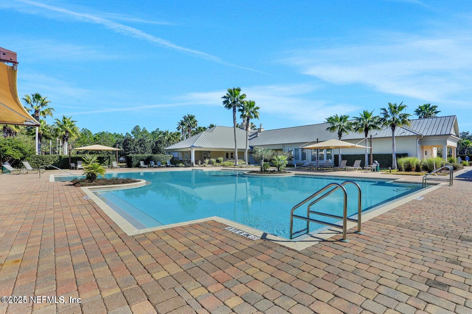 30 Pelican Pointe Road Ponte Vedra, FL 32081 - Photo 45 of 66 a view of a swimming pool with an outdoor space and seating area