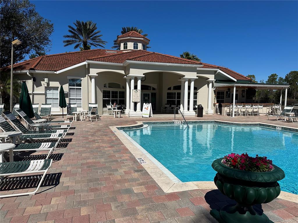 8411 Crystal Cove Loop Kissimmee, FL 34747 - Photo 22 of 43 a view of a house with pool and chairs