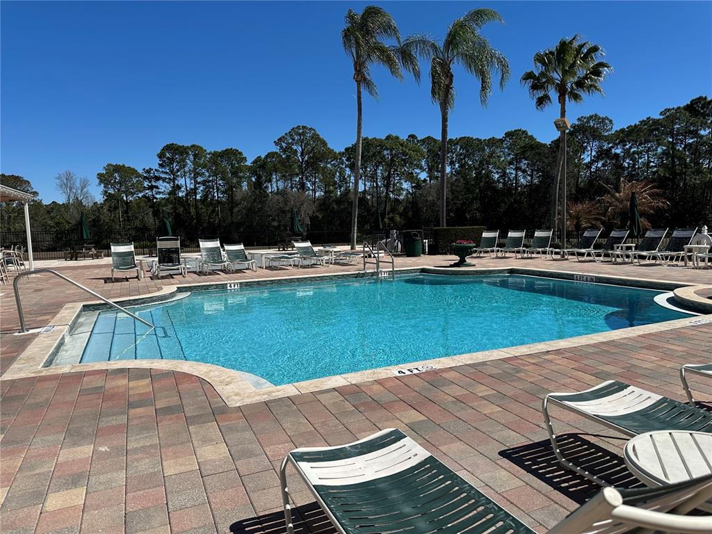 8411 Crystal Cove Loop Kissimmee, FL 34747 - Photo 26 of 43 a view of a swimming pool with a patio and a yard