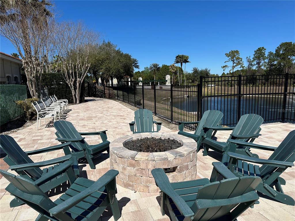 8411 Crystal Cove Loop Kissimmee, FL 34747 - Photo 29 of 43 a view of a patio with table and chairs with wooden floor and fence