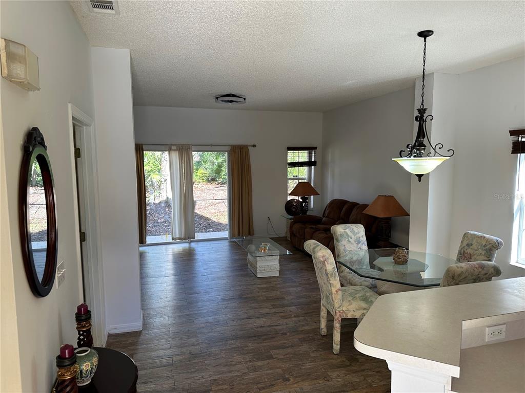 8411 Crystal Cove Loop Kissimmee, FL 34747 - Photo 10 of 43 a living room with furniture a window and a chandelier