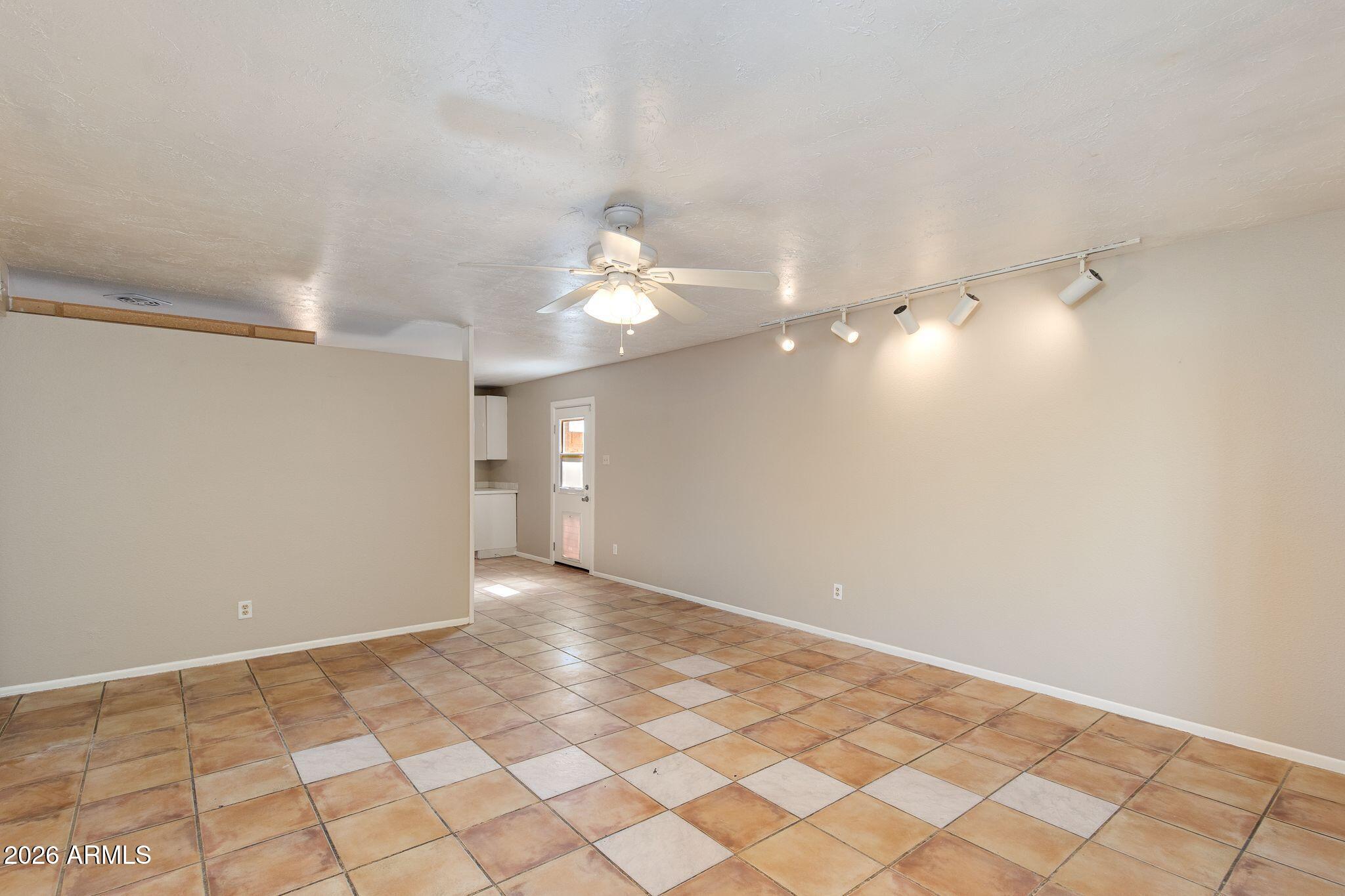 4415 East Chambers Street Phoenix, AZ 85040 - Photo 14 of 33 a view of an empty room with a chandelier fan