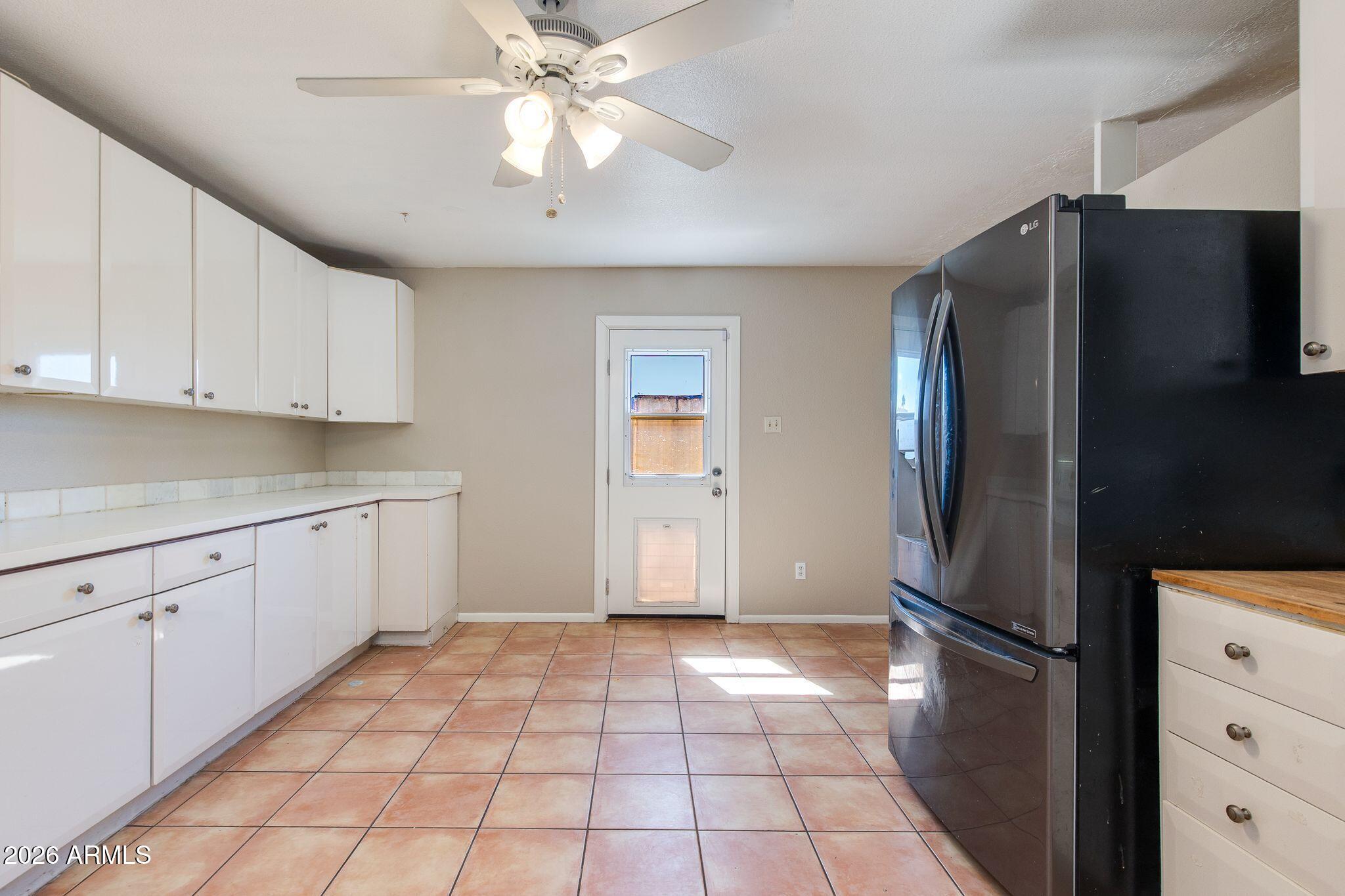 4415 East Chambers Street Phoenix, AZ 85040 - Photo 17 of 33 a kitchen with stainless steel appliances granite countertop a refrigerator and a stove top oven