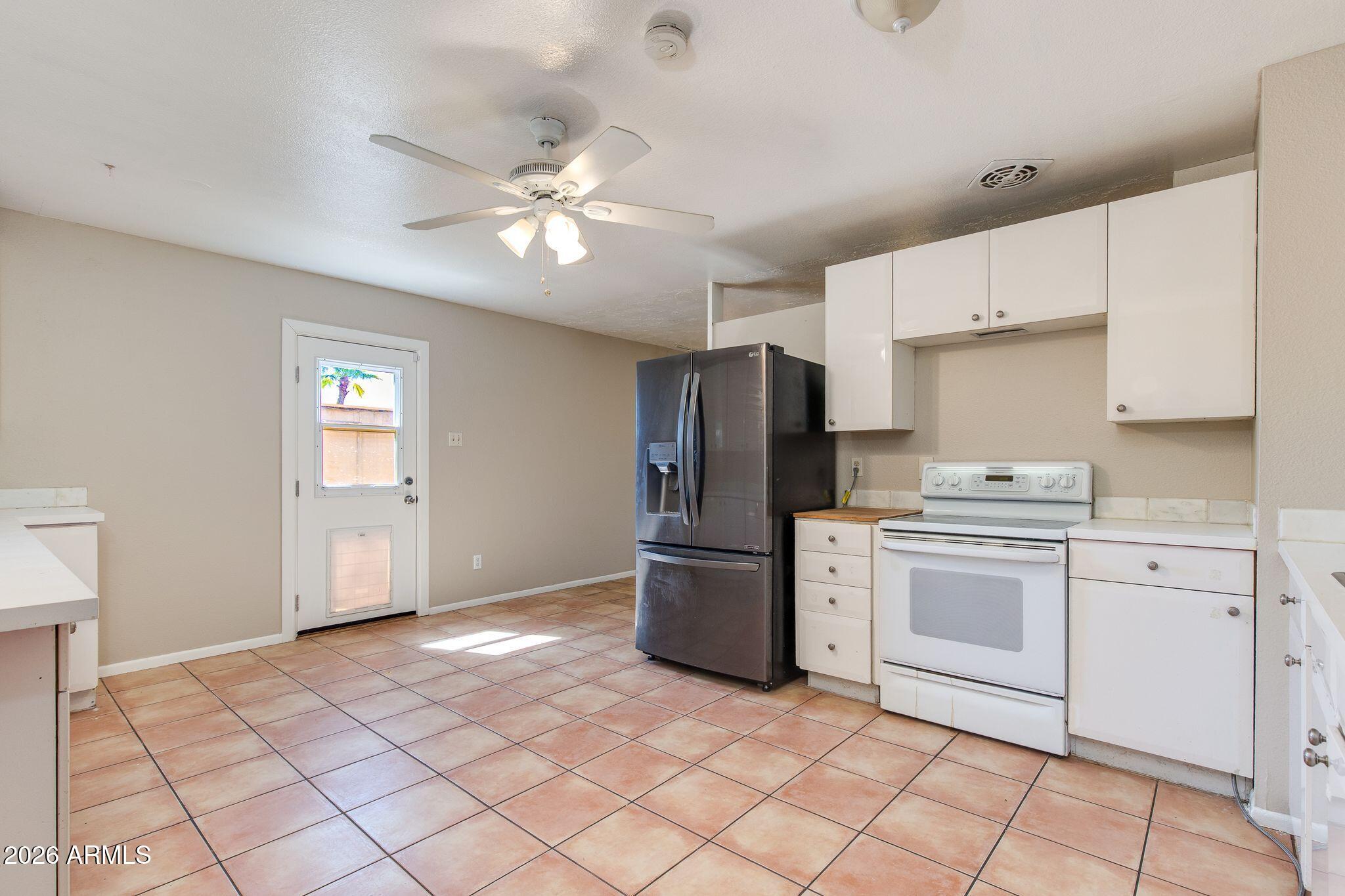 4415 East Chambers Street Phoenix, AZ 85040 - Photo 18 of 33 a kitchen with a refrigerator sink and stove