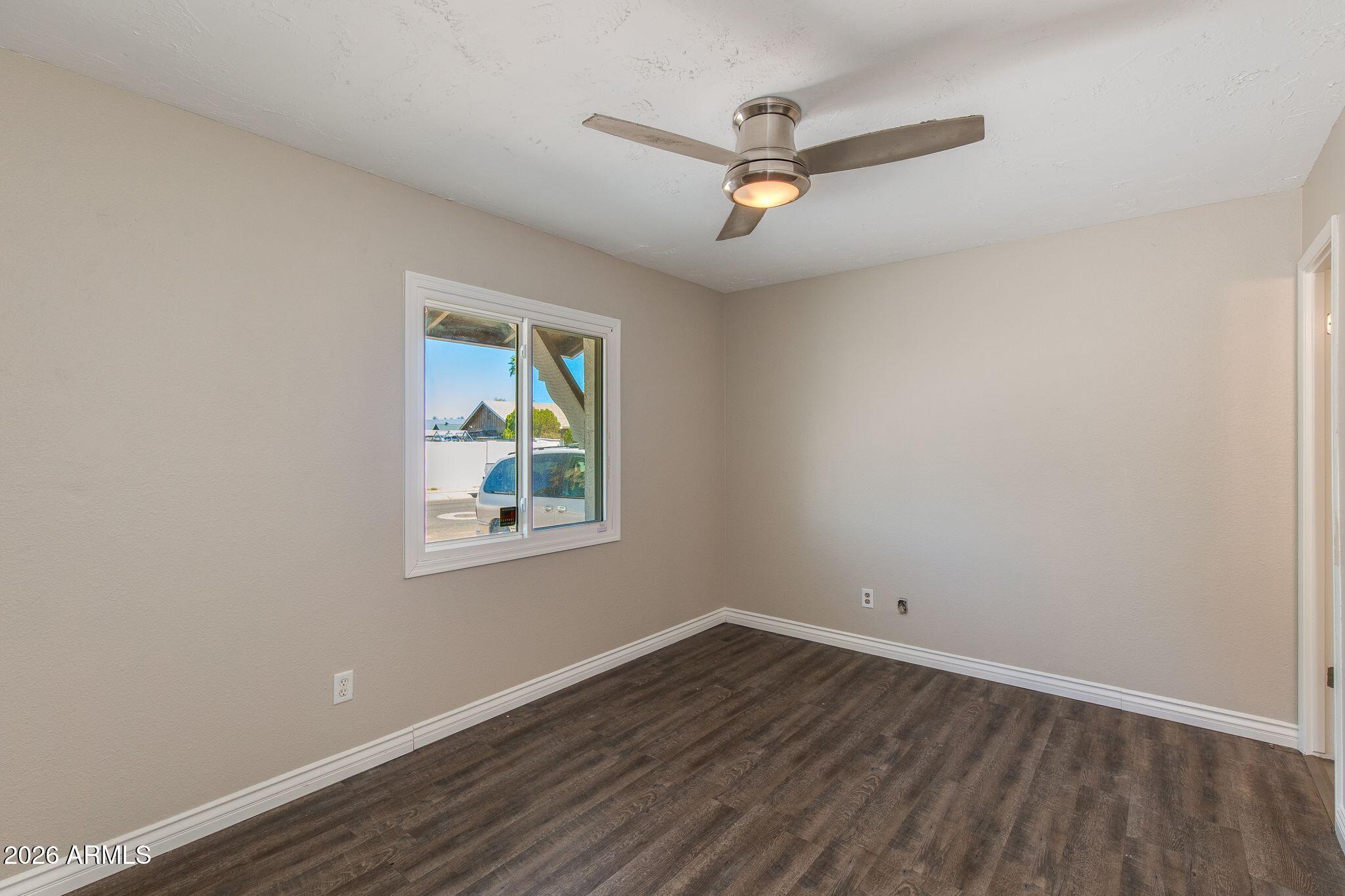 4415 East Chambers Street Phoenix, AZ 85040 - Photo 19 of 33 wooden floor in an empty room with a window