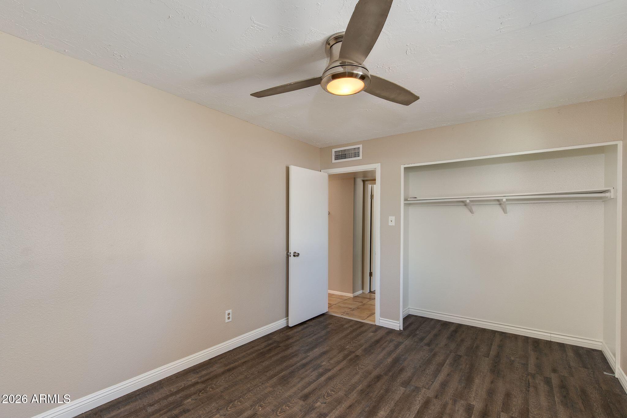 4415 East Chambers Street Phoenix, AZ 85040 - Photo 20 of 33 a view of an empty room with wooden floor