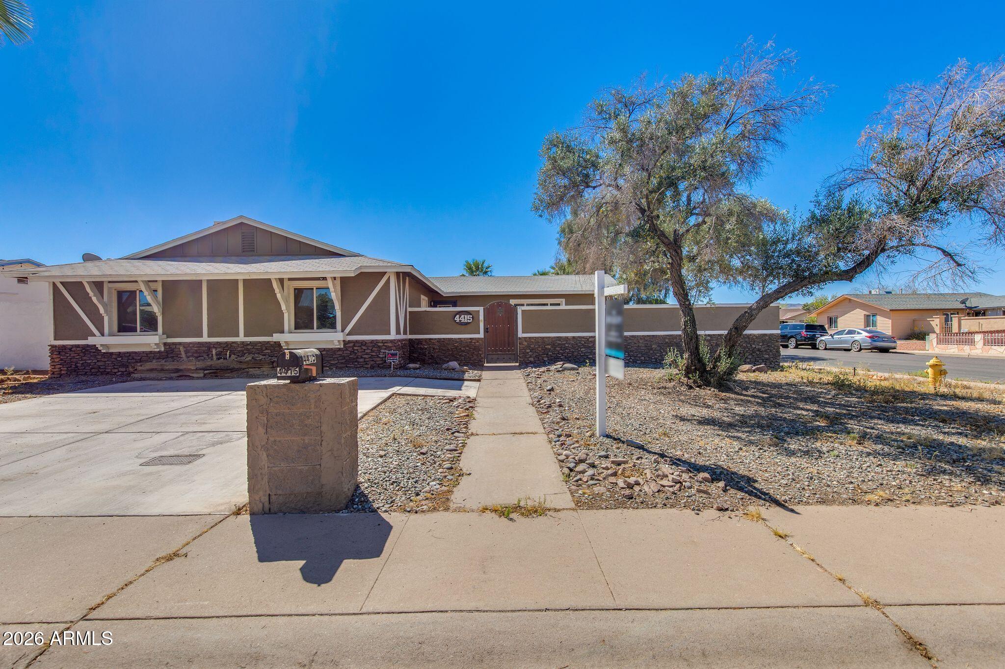 4415 East Chambers Street Phoenix, AZ 85040 - Photo 2 of 33 a front view of a house with a yard
