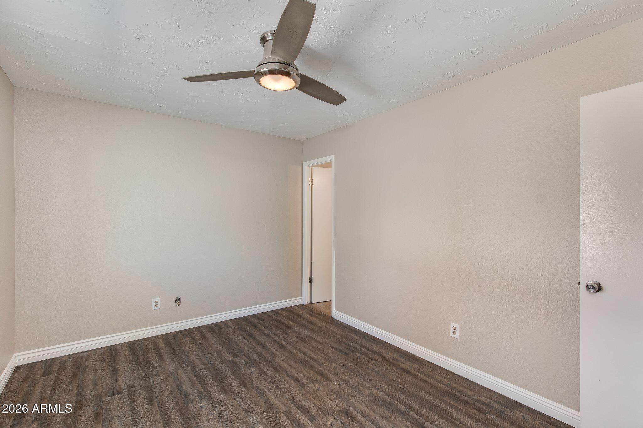4415 East Chambers Street Phoenix, AZ 85040 - Photo 21 of 33 a view of an empty room and wooden floor