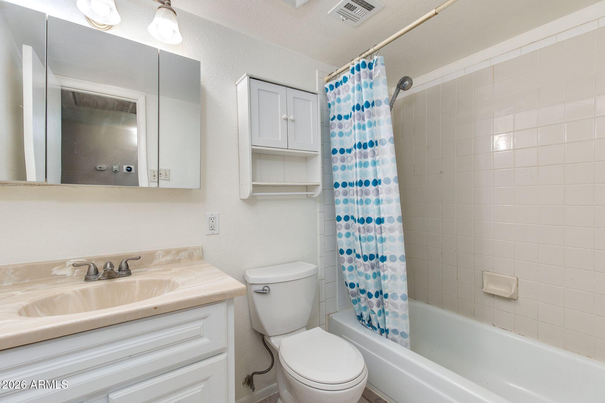 4415 East Chambers Street Phoenix, AZ 85040 - Photo 26 of 33 a bathroom with a sink toilet and shower