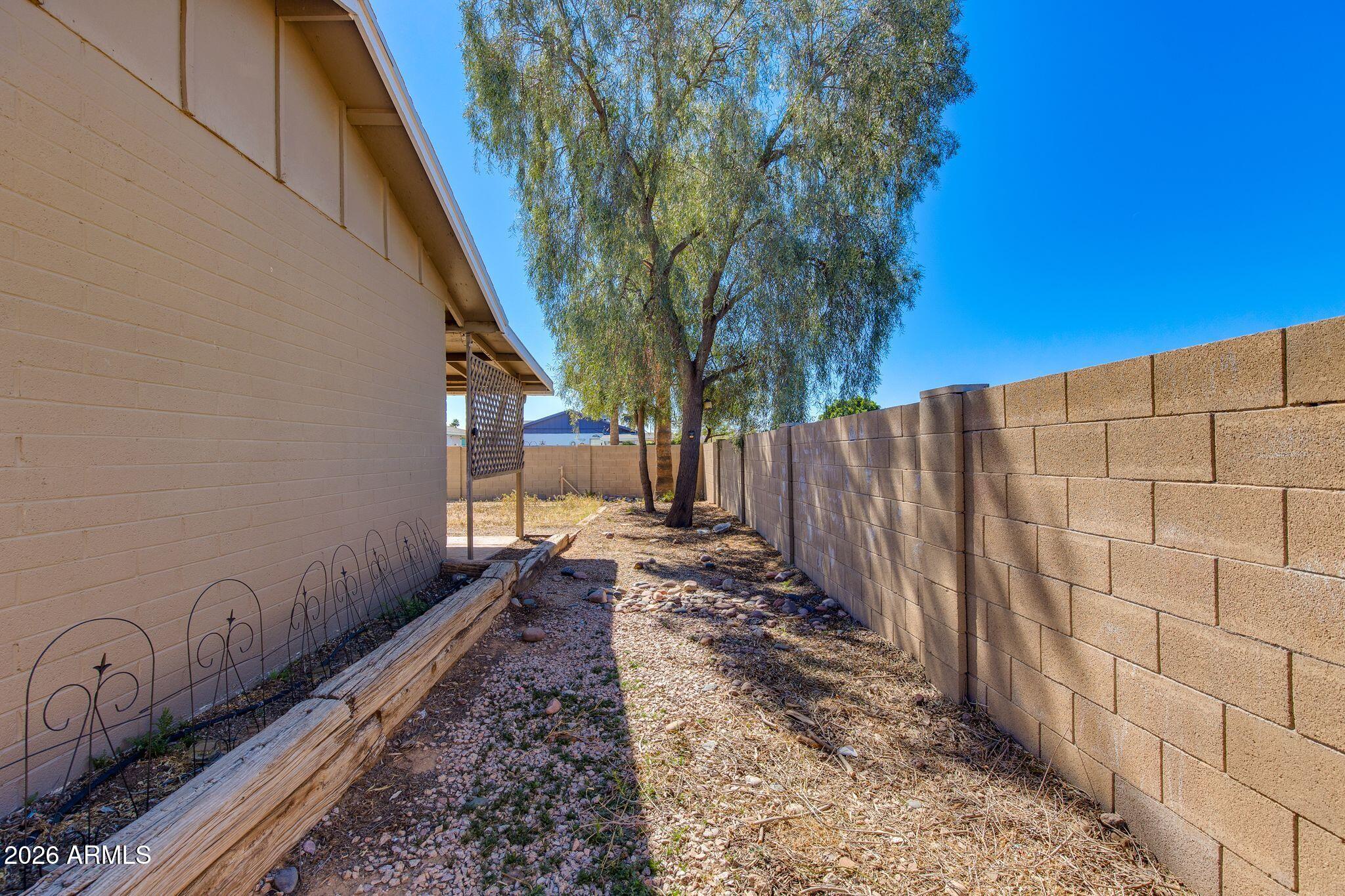 4415 East Chambers Street Phoenix, AZ 85040 - Photo 29 of 33 a view of a pathway of a building with wooden fence