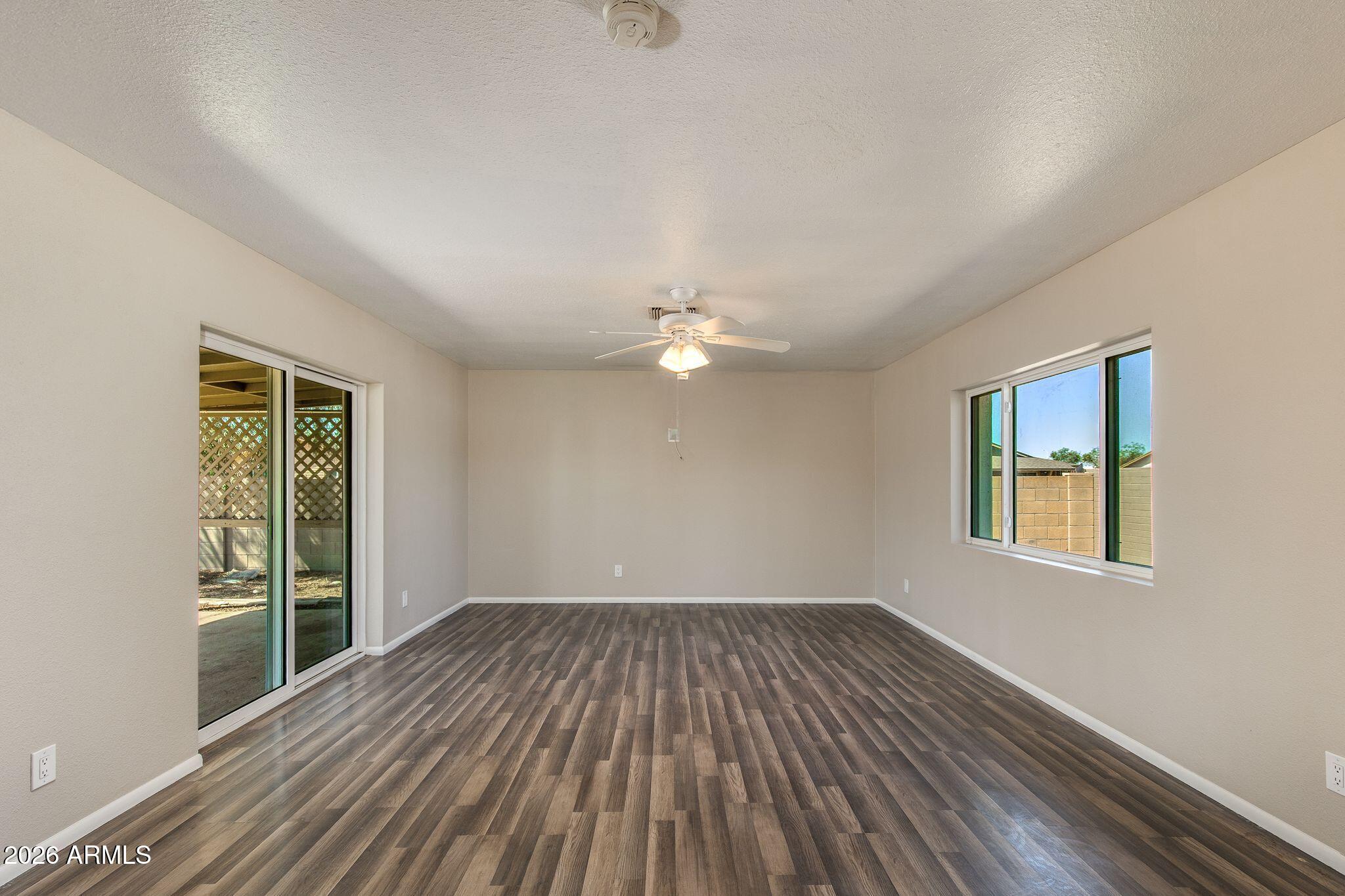 4415 East Chambers Street Phoenix, AZ 85040 - Photo 9 of 33 wooden floor in an empty room with a window