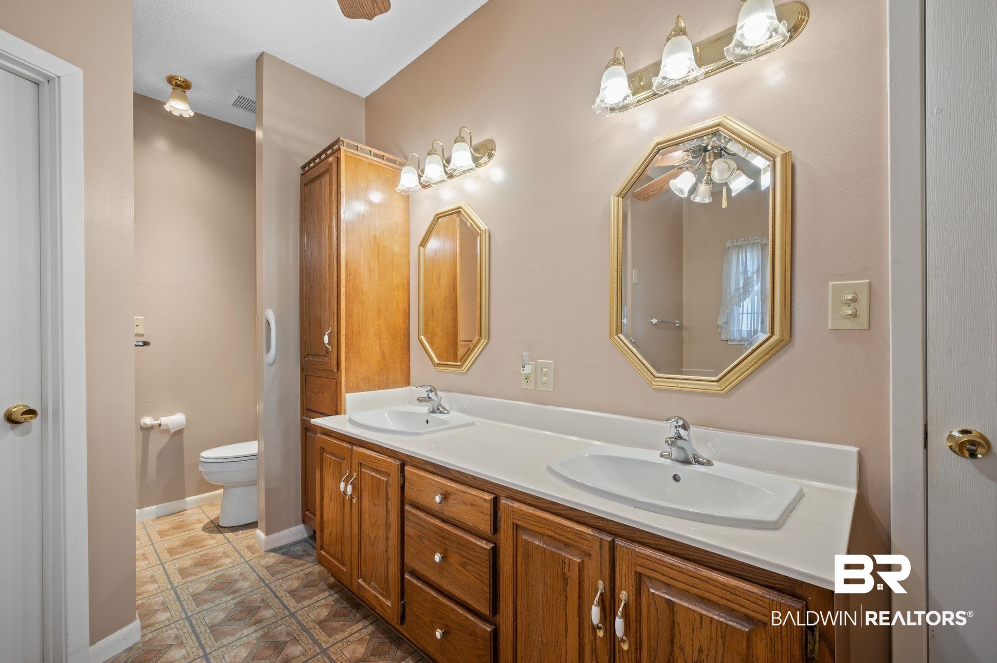 15801 Maytower Road Bay Minette, AL 36507 - Photo 25 of 43 Bathroom featuring tile patterned floors, vanity, toilet, and ceiling fan