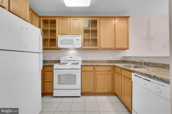a kitchen with a stove top oven sink and cabinets