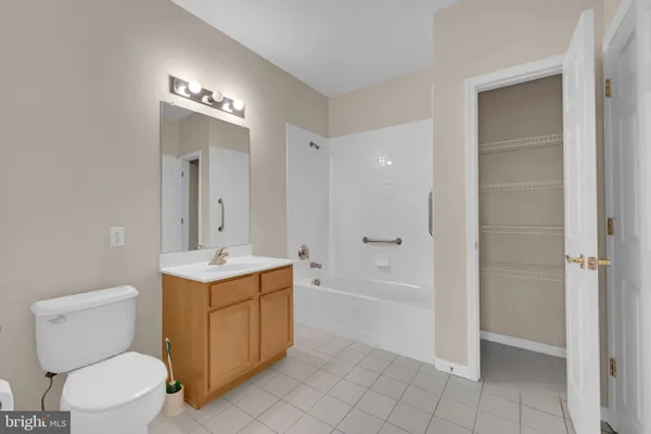 a spacious bathroom with a toilet sink and mirror