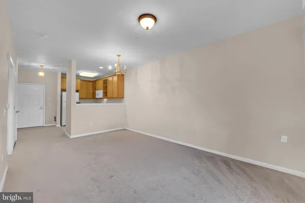 an empty room with a fan and a mirror