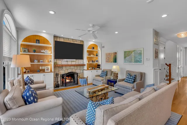 a living room with furniture a fireplace and a flat screen tv