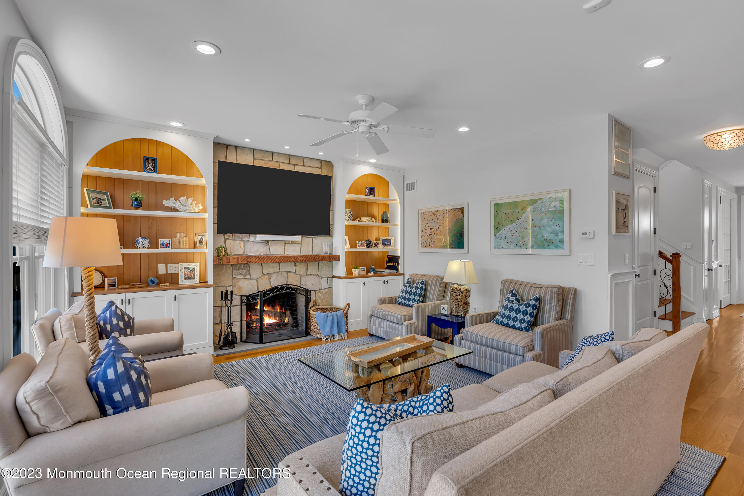 105 Beacon Boulevard Sea Girt, NJ 08750 - Photo 11 of 26 a living room with furniture a fireplace and a flat screen tv