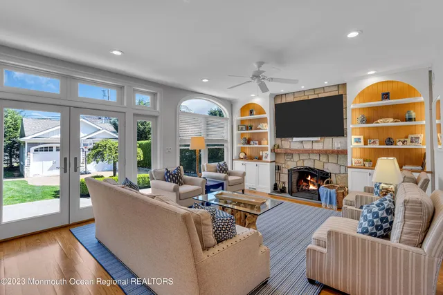 a living room with furniture fireplace and a large window