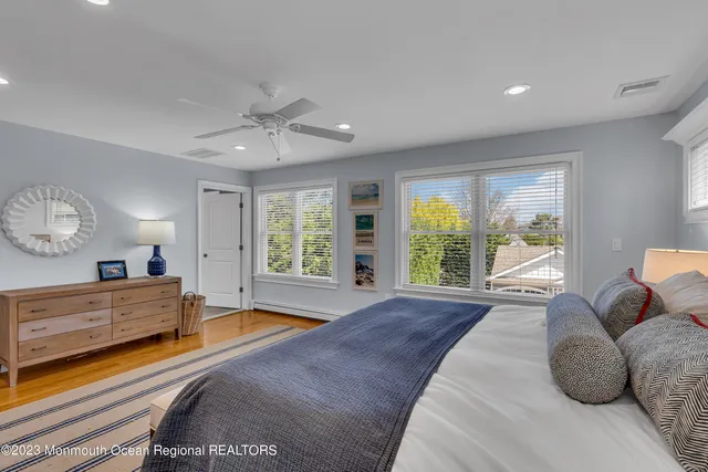a spacious bedroom with a large bed and a large window