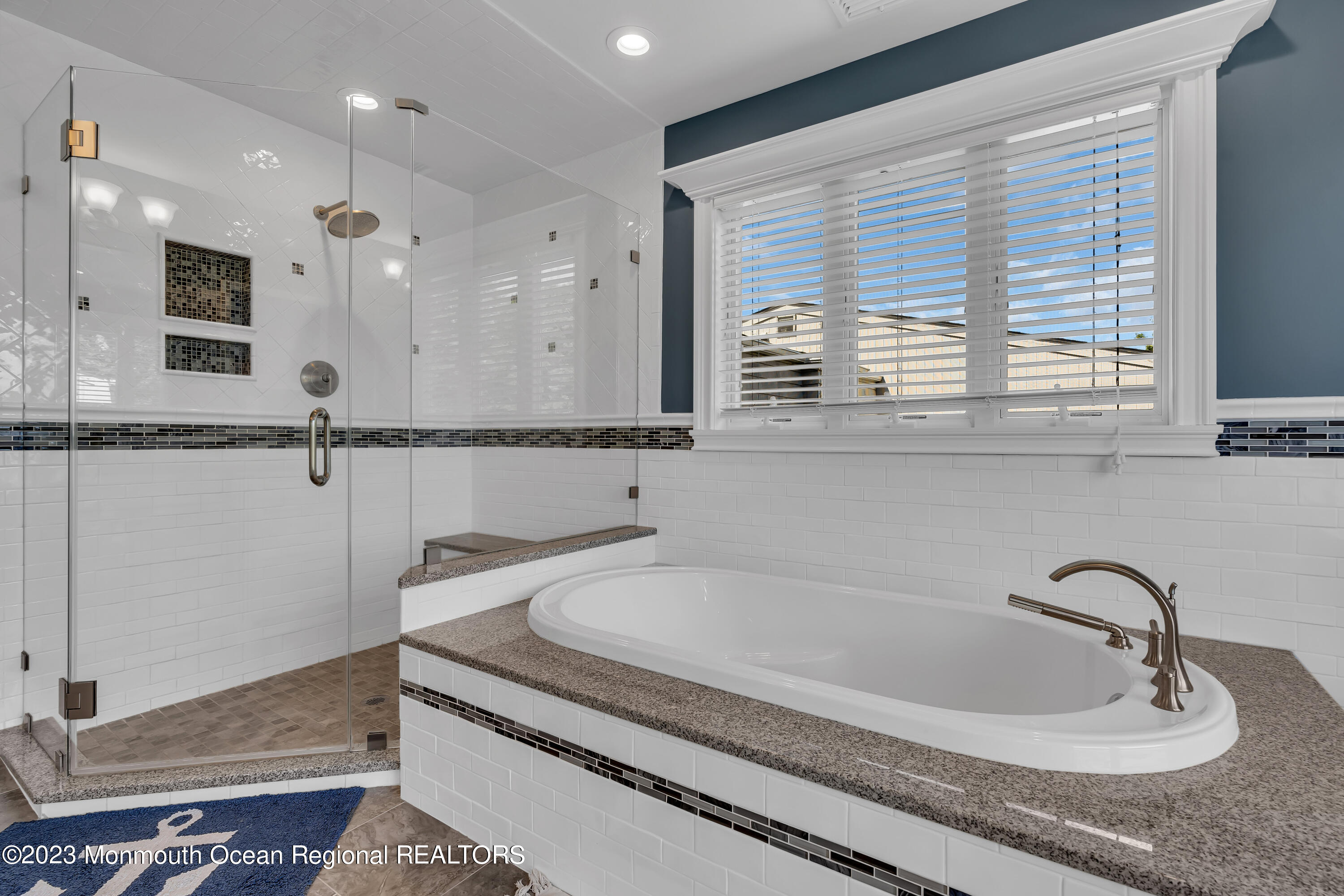 105 Beacon Boulevard Sea Girt, NJ 08750 - Photo 17 of 26 a bathroom with a granite countertop sink and a mirror