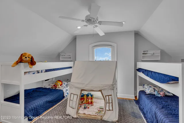 a living room with furniture and a baby crib