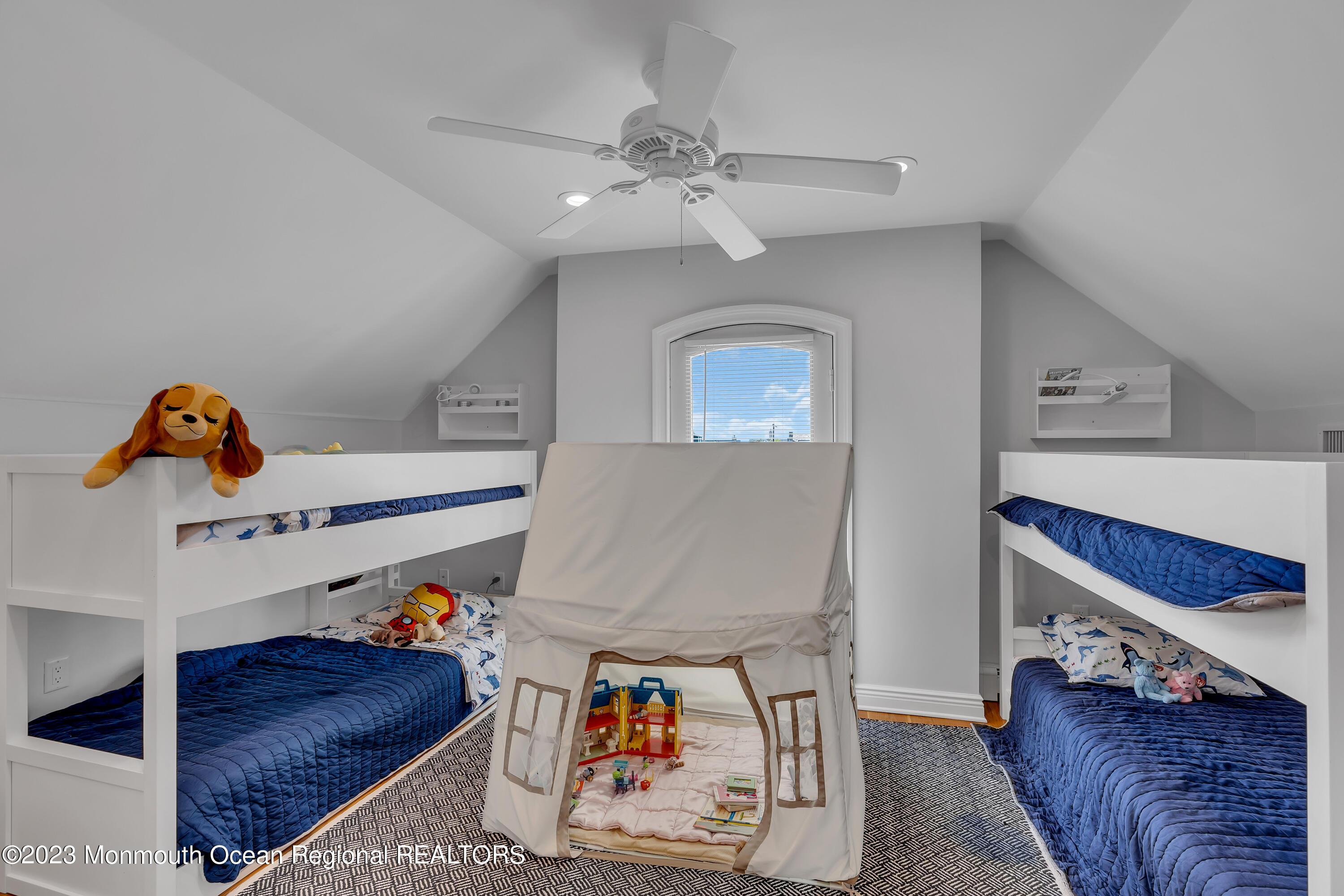 105 Beacon Boulevard Sea Girt, NJ 08750 - Photo 22 of 26 a living room with furniture and a baby crib