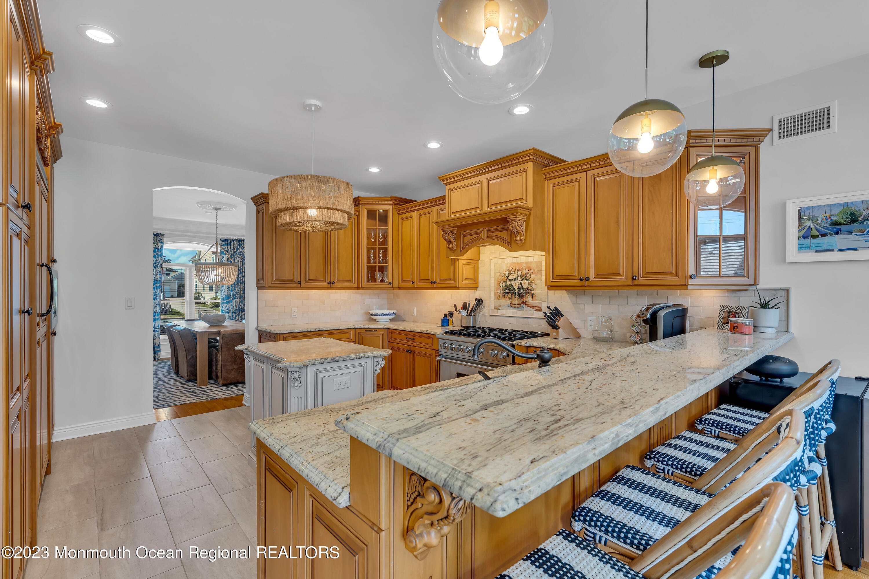 105 Beacon Boulevard Sea Girt, NJ 08750 - Photo 7 of 26 a kitchen with center island and a chandelier