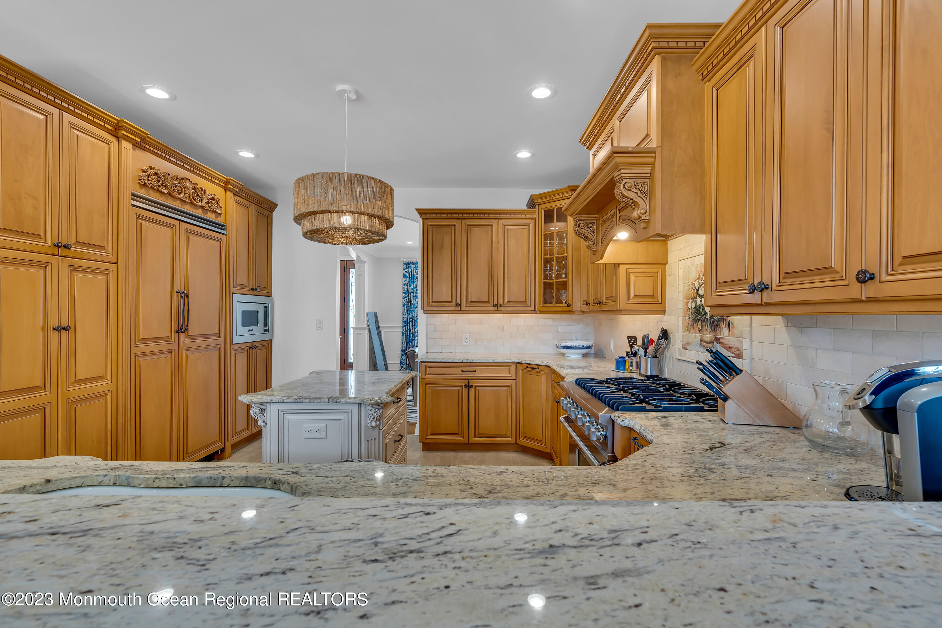 105 Beacon Boulevard Sea Girt, NJ 08750 - Photo 8 of 26 a kitchen with stainless steel appliances granite countertop a sink a stove and a refrigerator