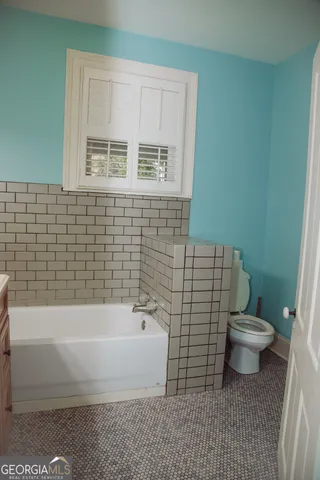 a view of hallway with closet and a window