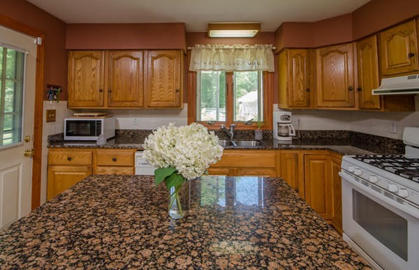 328 Mendall Road Acushnet, MA 02743 - Photo 11 of 30 a kitchen with granite countertop a stove a sink and a microwave