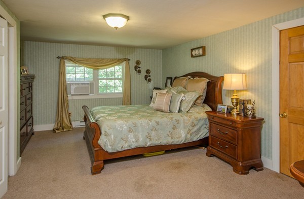 328 Mendall Road Acushnet, MA 02743 - Photo 19 of 30 a spacious bedroom with a bed and wooden floor