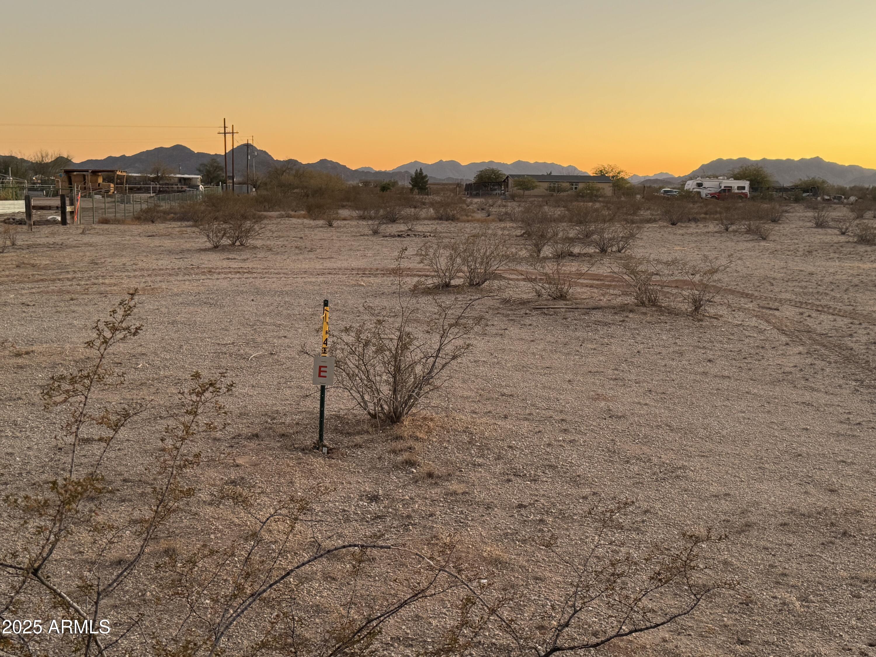 2241 South Alamo Road Buckeye, AZ 85326 - Photo 1 of 8 a view of a dry field with a mountain in the background