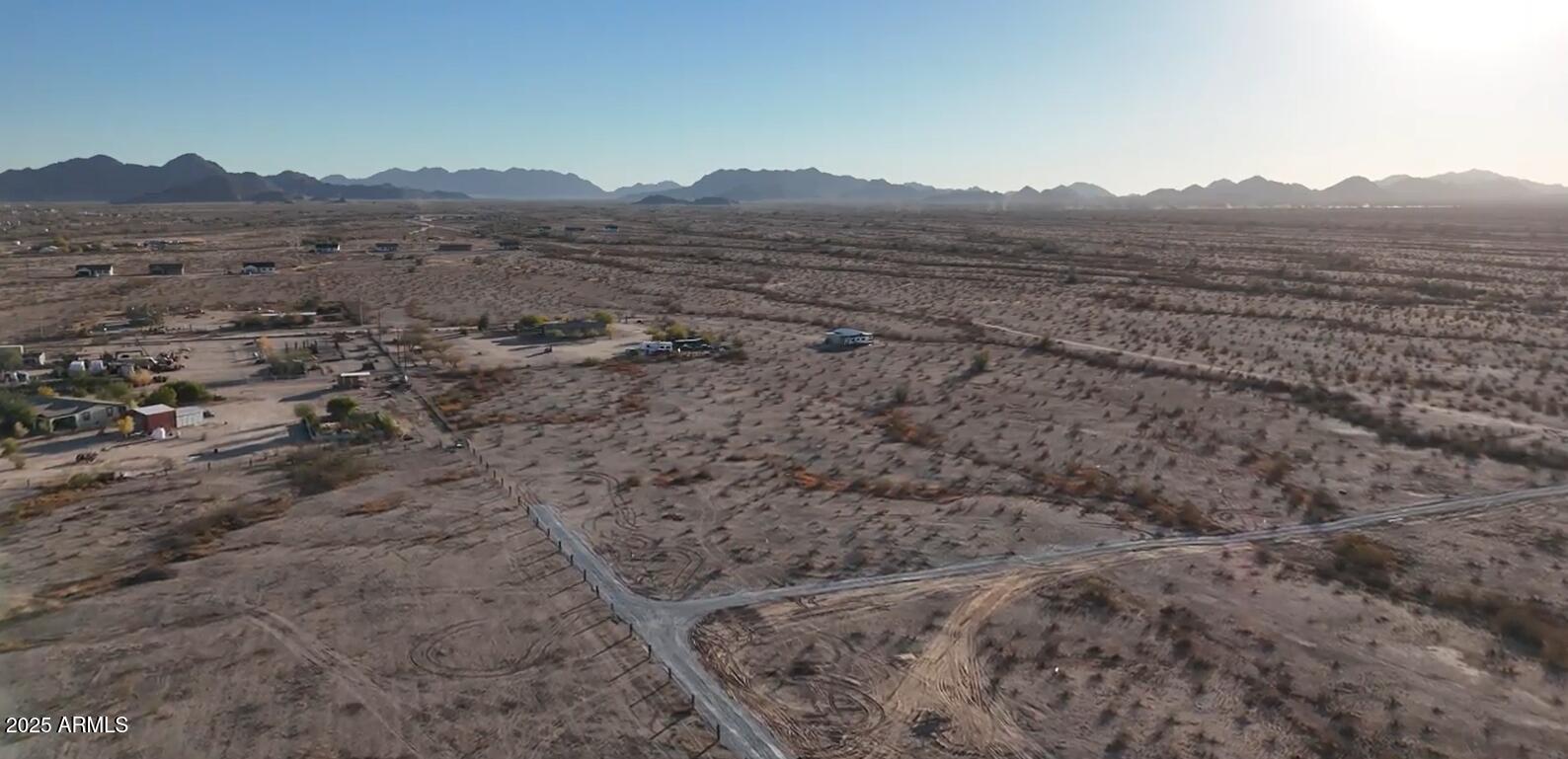 2241 South Alamo Road Buckeye, AZ 85326 - Photo 2 of 8 a view of a dry field with mountains in the background