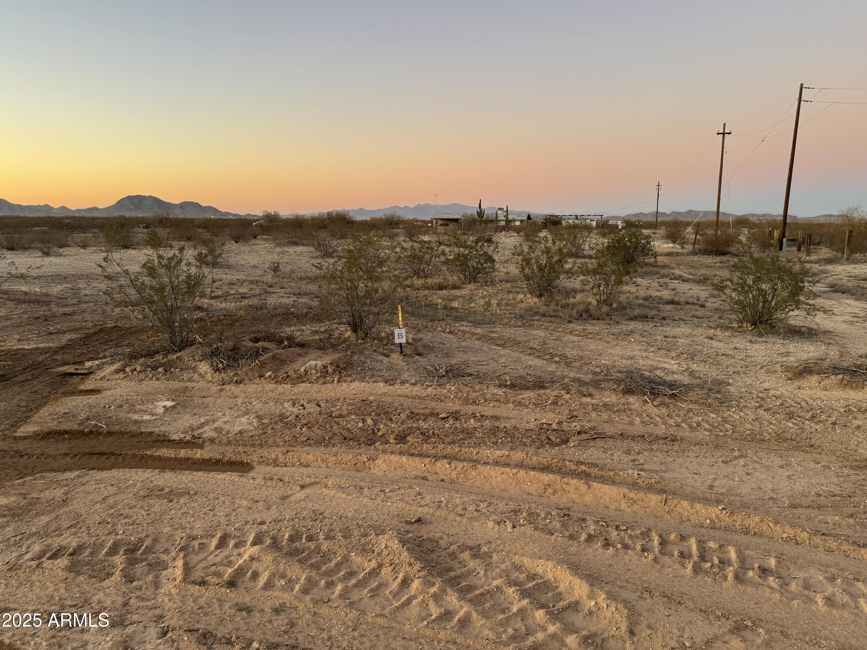 2241 South Alamo Road Buckeye, AZ 85326 - Photo 6 of 8 a view of a dry yard with wooden fence
